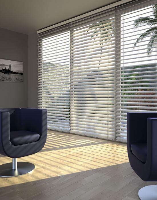 white wooden blind open with sun shining through reflecting on wooden floor.