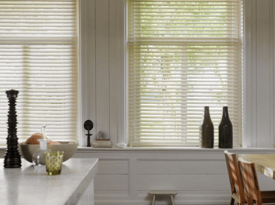 kitchen island with two white wooden blinds above it.