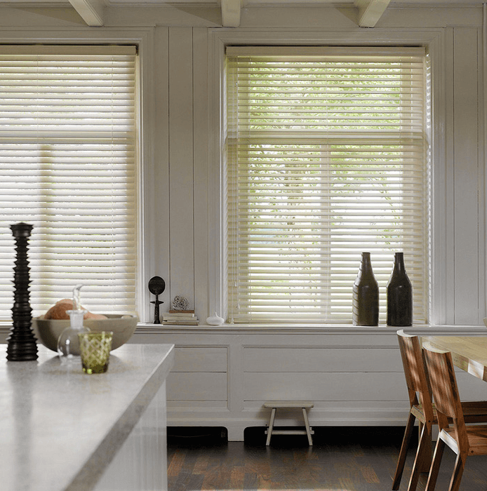 kitchen island with two white wooden blinds above it.