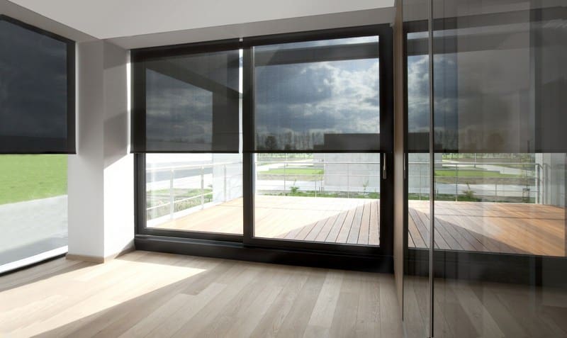 sun filter roller blinds in living room looking out the deck