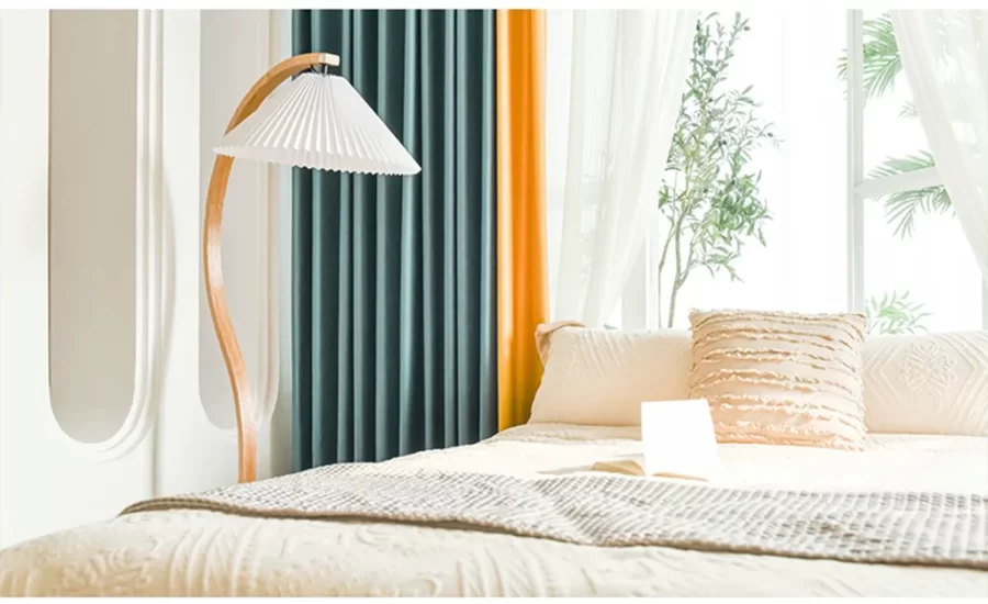 curtain on window above bed in orange and green colour