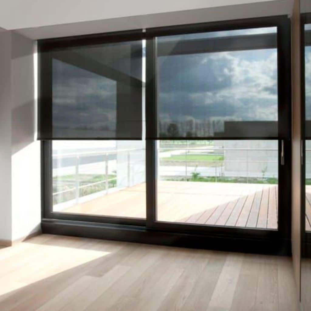 sunscreen black roller blind on sliding door to backyard
