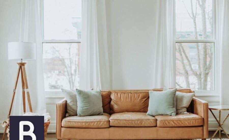 white sheer curtains behind leather couch